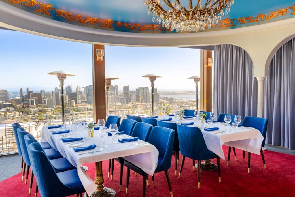The Rotunda private dining room at Mister A's with crystal chandelier and panoramic downtown San Diego views