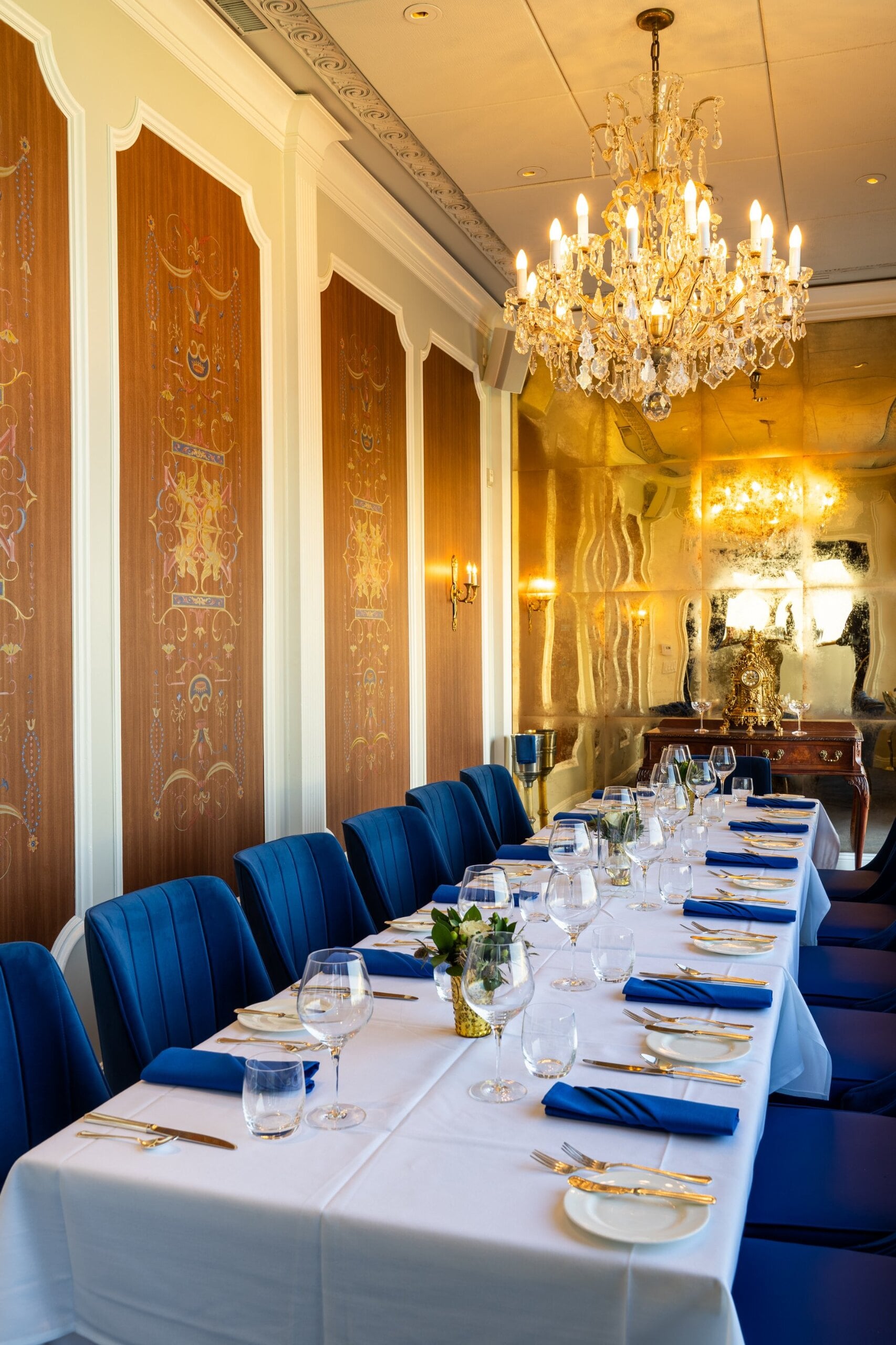 Gold panelled walls and antique mirror in The Blue Room private dining room at Mister A's San Diego