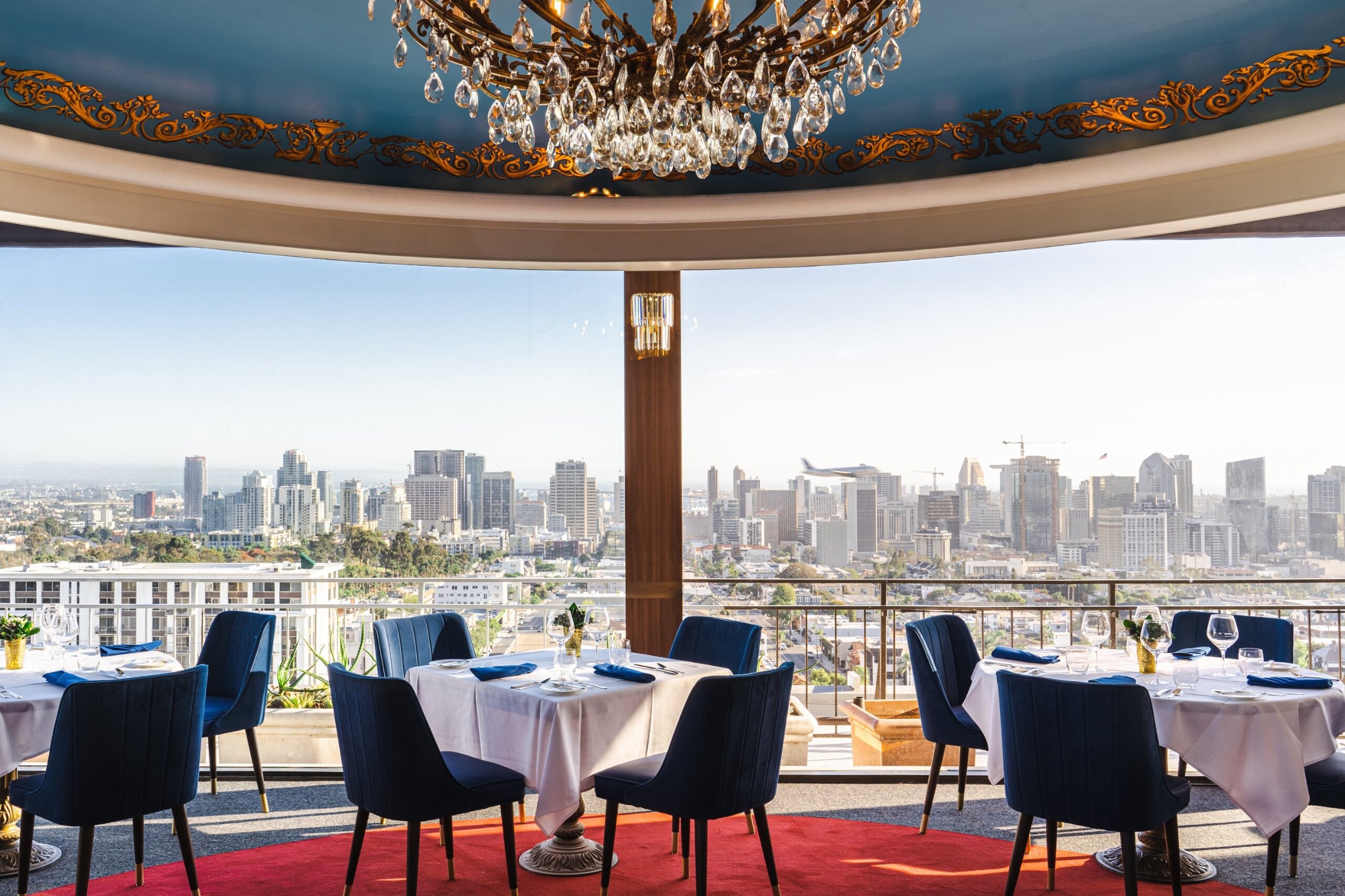 The Rotunda at Mister A's set for a private dinner beneath its blue and gold domed ceiling, downtown San Diego through the curved windows